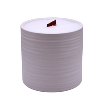 Hand Poured Large Scented Candle in a cylindrical light white ribbed ceramic vessel with white wax and a wooden wick.