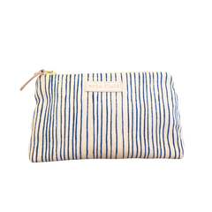 Royal Skinny Stripe Pouch in off-white cotton fabric with vertical navy blue hand-drawn stripes, gold zipper, and tan leather pull.