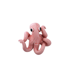 Pink Octopus Objet, glossy pink ceramic sculpture featuring a whimsical octopus shape with curled tentacles and black eyes.