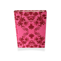 Handmade Linen Notebook | Large, fuchsia linen with deep red symmetrical botanical pattern, standing upright on a white surface.