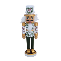 Custom Mistletoe Kiss Nutcracker, a white and green wooden figure with gold details, red mistletoe hat, and leafy pattern.