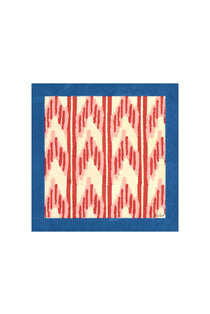 Arrow Red Napkin, rectangular cotton textile with vibrant red arrow ikat pattern on cream, blue border, displayed flat.