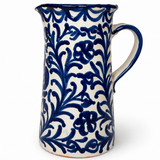 Pomegranate Straight Pitcher, a cream ceramic pitcher with a cobalt blue floral vine pattern and sturdy handle.