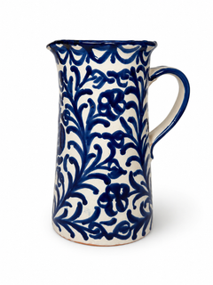 Pomegranate Straight Pitcher, a cream ceramic pitcher with a cobalt blue floral vine pattern and sturdy handle.