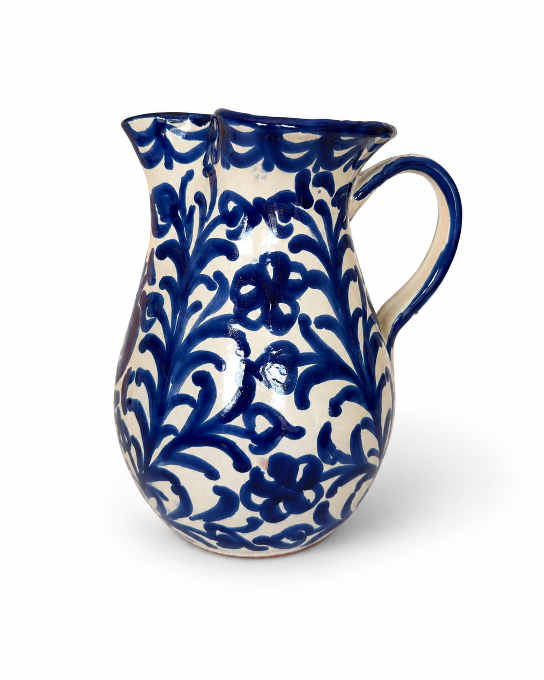 Pomegranate Round Pitcher, cream glazed ceramic with deep blue floral vine pattern, double spout, and handle.