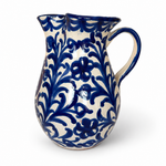 Pomegranate Round Pitcher, cream glazed ceramic with deep blue floral vine pattern, double spout, and handle.