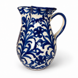 Pomegranate Round Pitcher, cream glazed ceramic with deep blue floral vine pattern, double spout, and handle.