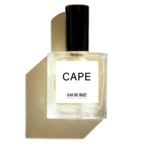 Eau de Buzz | An Innovative Perfume + Bug Repellent, clear rectangular glass bottle, black cap, white 'CAPE' label, strong shadow.