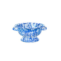 Splatter Berry Collander, round enamelware with a blue and white splatter pattern, featuring two handles and a pedestal base.