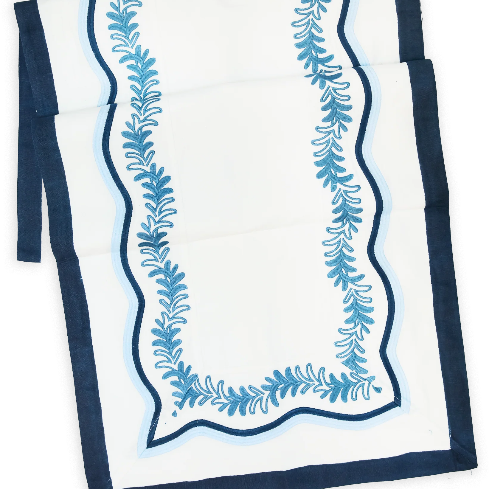 Palmerie Runner in white cotton, with a navy border and two-tone blue wavy trim around embroidered botanical vines.