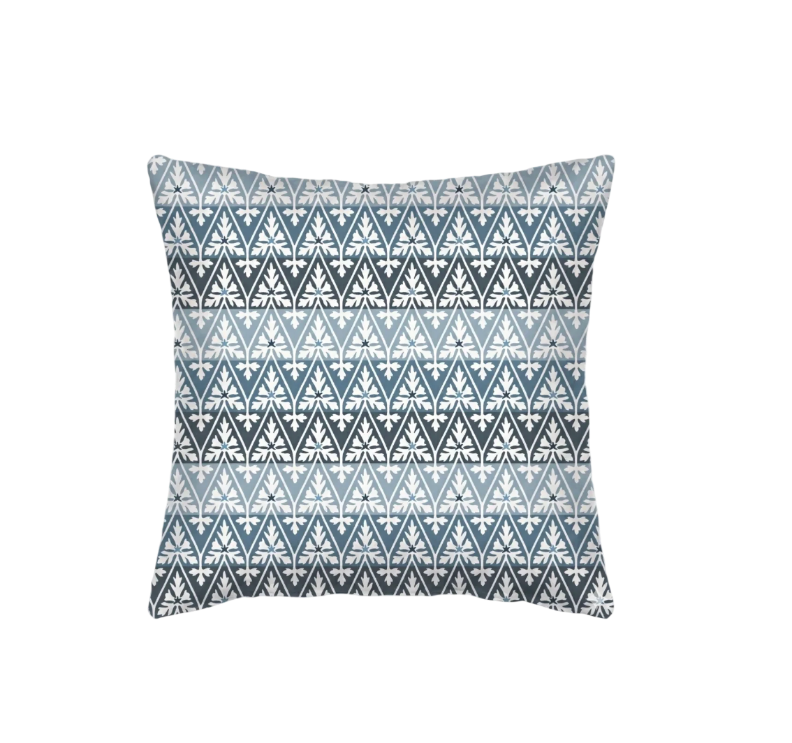 Ines Pillow, square decorative fabric pillow with repeating white botanical pattern on graduated blue horizontal bands.