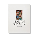 Italian Summer by Natalie Obradovich, a cream hardcover book featuring an inset photo of colorful striped beach umbrellas, subtly displayed.