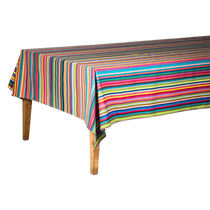 Salvador Coated Tablecloth, a rectangular multicolor striped coated fabric draped on a light brown wooden table.