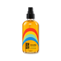 Outer Being Face & Body Oil | Cathedral Grove, amber oil in clear glass bottle, black sprayer, rainbow pattern label on white.