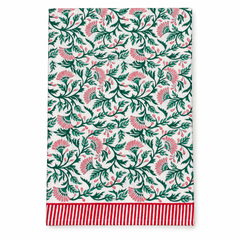 Blockprint Christmas Tablecloth, white cotton with pink floral pattern, green leaves, and a red striped border, folded.