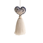 Mexican Heart Tassel: dark blue embroidered heart with cream floral design and a cream thread tassel, hanging.