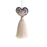 Mexican Heart Tassel: dark blue embroidered heart with cream floral design and a cream thread tassel, hanging.