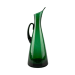 Blenko Glass Floor Pitcher in tall, tapered emerald green glass with a black handle and elegant flared spout.