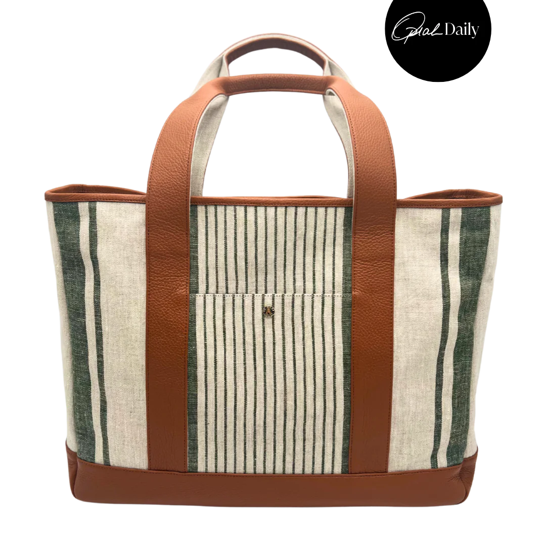 The Freddy Tote Bag, natural linen with dark green stripes, brown leather trim, handles, and base, with a front pocket.