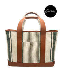The Freddy Tote Bag, natural linen with dark green stripes, brown leather trim, handles, and base, with a front pocket.