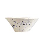 Blue Splatter Serving Bowl, white ceramic with dark blue splatter pattern and a wavy flared rim.