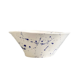 Blue Splatter Serving Bowl, white ceramic with dark blue splatter pattern and a wavy flared rim.