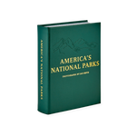 America's National Parks" Book, dark green leather with embossed mountain range and gold foil text, standing on a white surface.