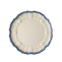 Eva Melamine Dinner Plate, round cream melamine plate with a scalloped dark blue and light blue striped rim, shown from above.