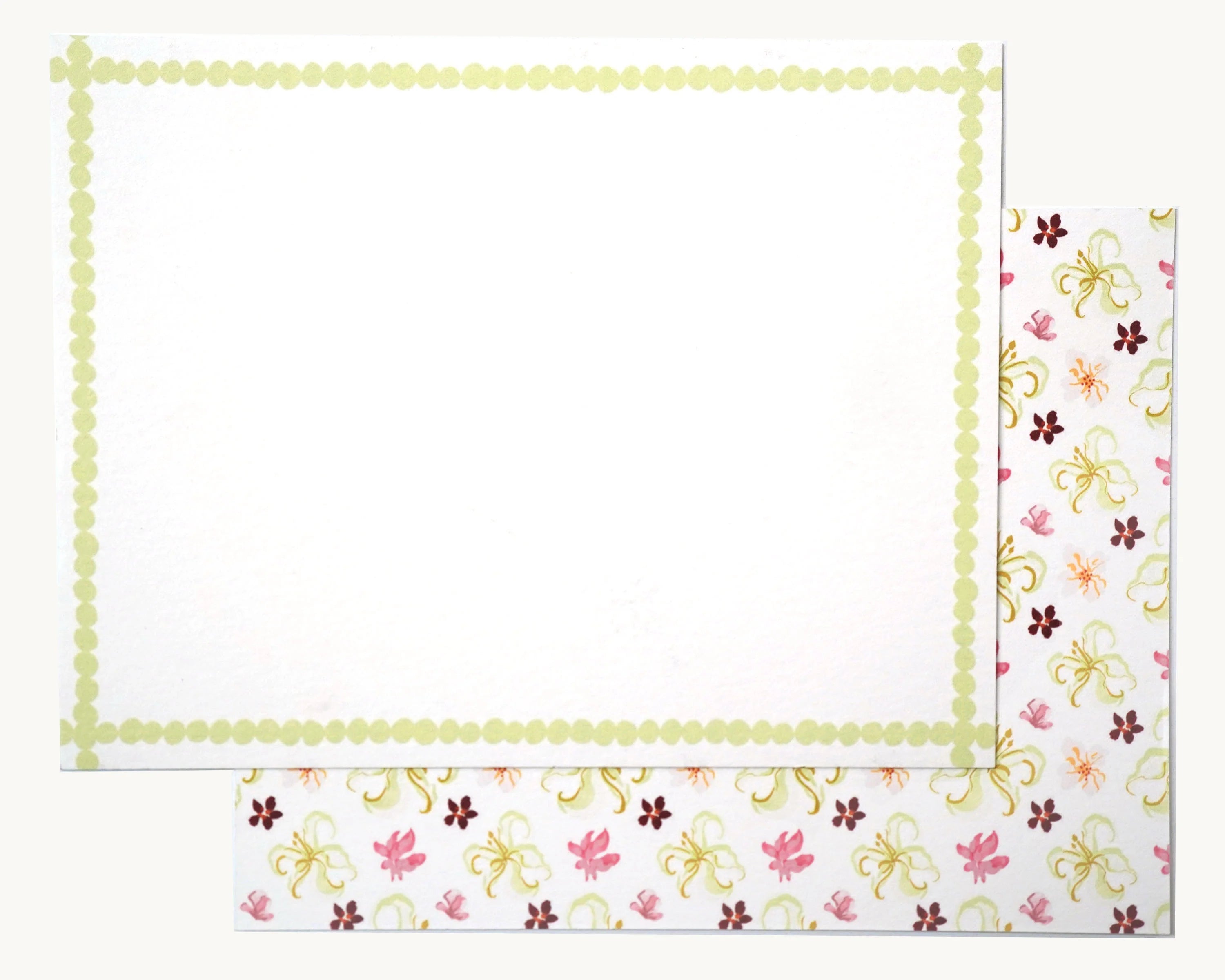 Lucy Stationery Set: White notecard with light green dotted border, overlapping a white sheet with pink, green, maroon floral pattern.