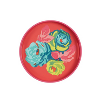 Nizam Geranium Round Tray, lacquered coral pink with vibrant multi-colored floral pattern of stylized teal, lime, and fuchsia.
